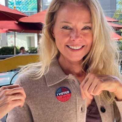 Kristina Wagner is showing the I voted badge in the picture.